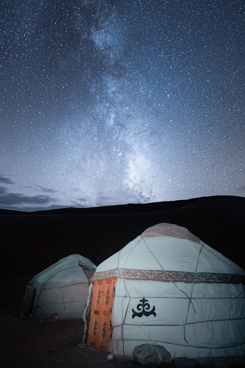 Tradycyjne jurty w Kirgistanie nocą pod rozgwieżdżonym niebem z widoczną Drogą Mleczną w górskim krajobrazie Paweł mazur