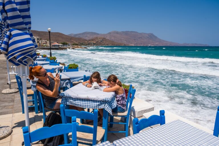 Rodzina siedząca w typowej greckiej tawernie w Kissamos, Kreta, Grecja